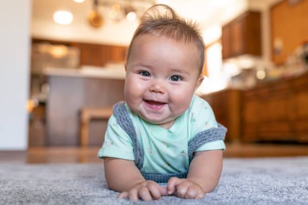 Baby laying on carpet flooring | Vic's Carpet & Flooring