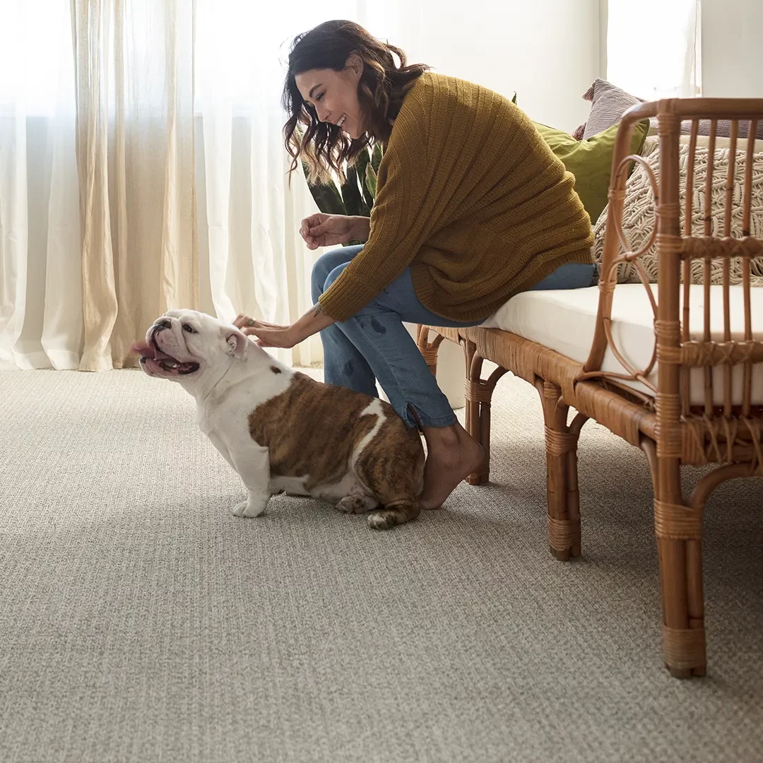 Capet in sitting room with woman and dog | Vic's Carpet & Flooring